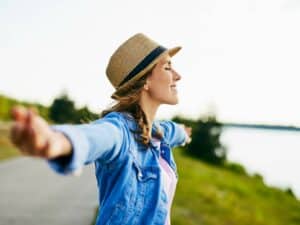 Woman holding the sun in her hands, how to improve mindfulness