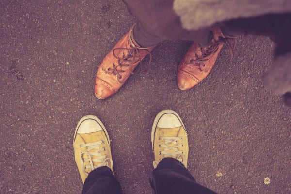 couple looking down at feet, representing how to Win at Online Dating with Bela Gandhi
