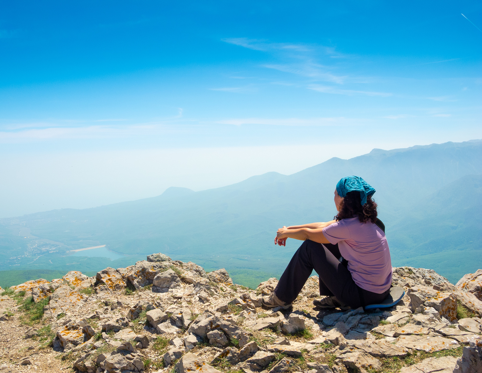Woman hiking looking out at the amazing view from the top. 10 Best Things About Being a Denver Life Coach.