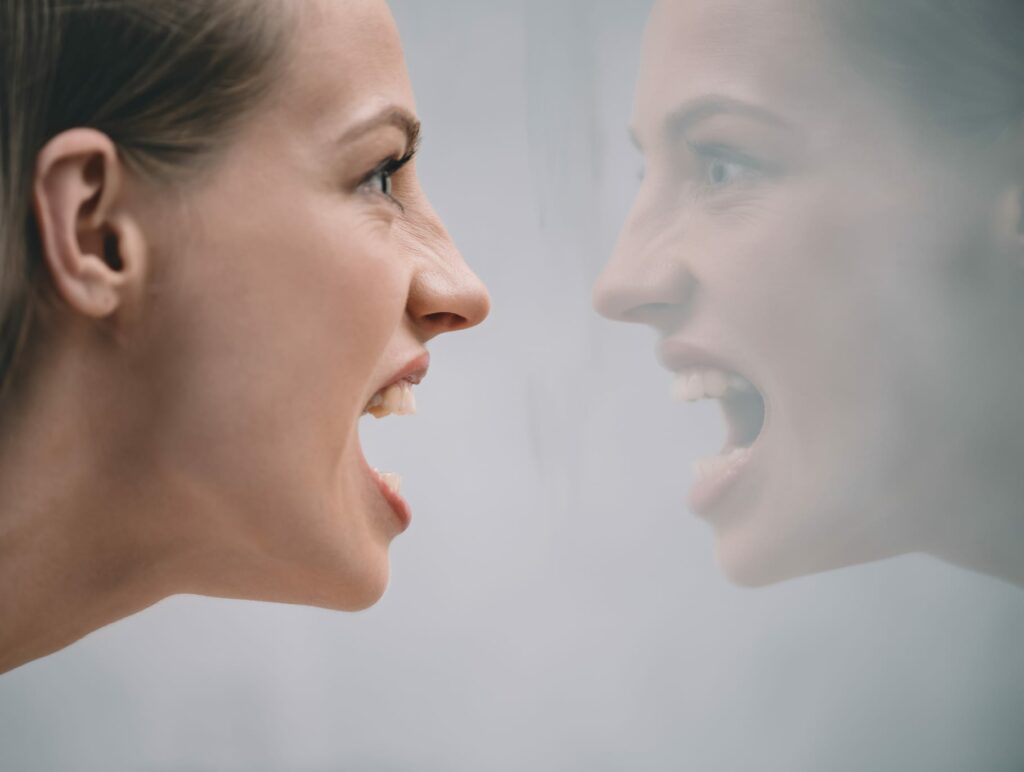 Woman screaming at her reflection - should you follow your emotional guidance system?