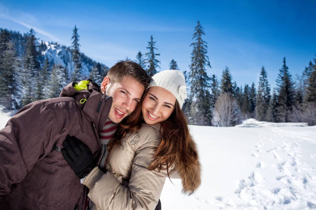 Affectionate couple taking a picture in the snow. Why am i still single?