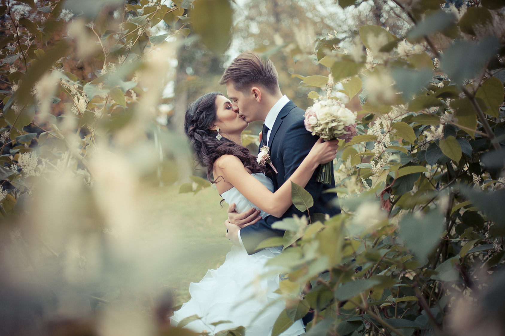 Couple in wedding attire kissing. How to Create a Lifetime of Love.