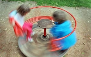 Children spinning on a playground spinner. toxic relationship patterns.