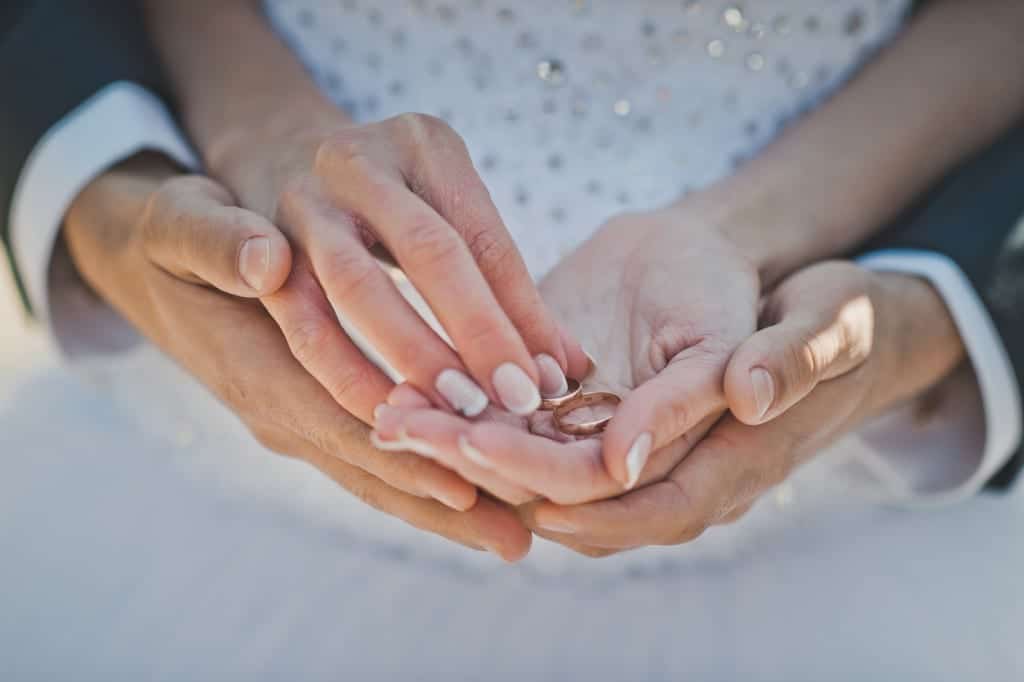 Wedding couple hands with rings best wedding ever representing How to Have the Best Wedding Ever