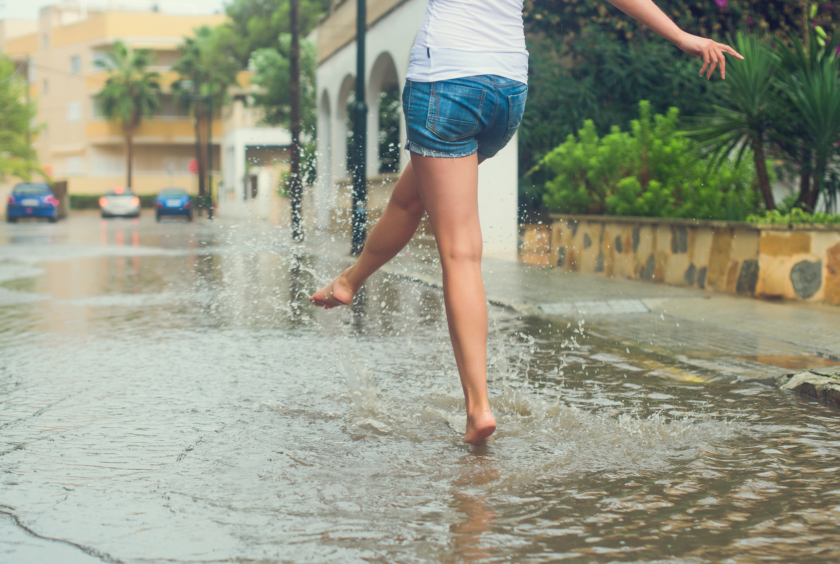 Woman dancing in a puddle. overcoming perfectionism