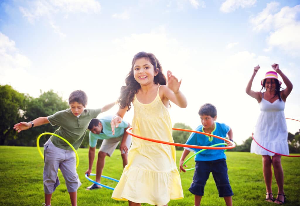 Kids hula-hooping family moving forward from Blended Family Problems.