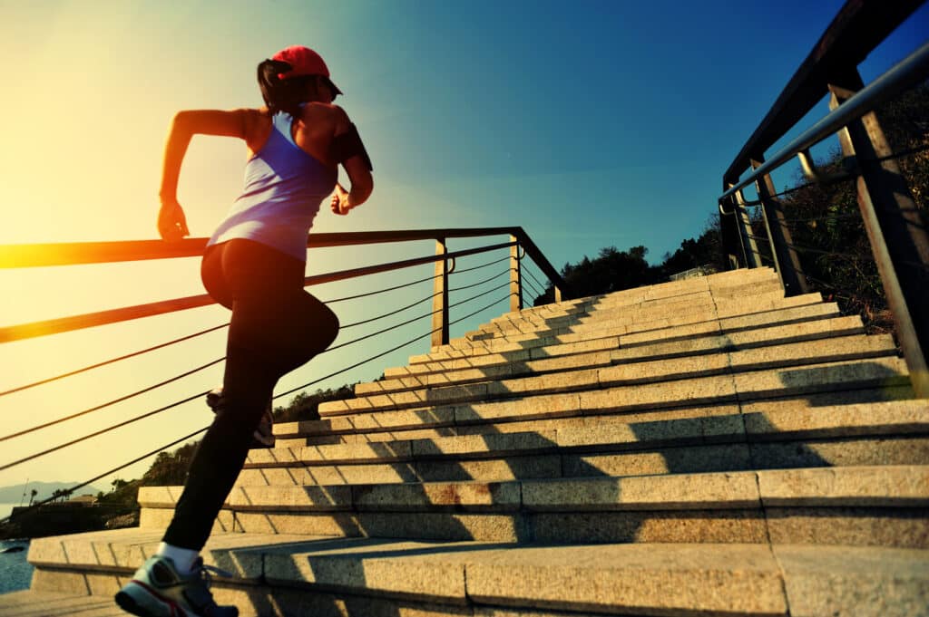 Woman running up stairs starting strong this new year