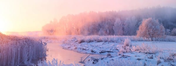 Snowing river scene at sunrise, representing The Gift of Unconditional Love