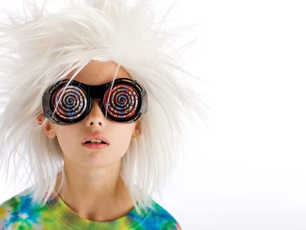 Kid with a wig and cool glasses. Here's some parenting advice for parenting without losing your mind, or your marriage