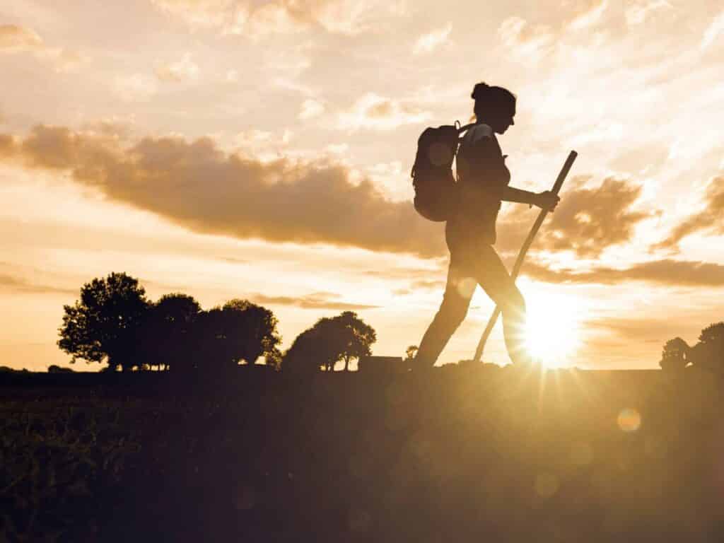 Person hiking as sunset ready to make lasting change.