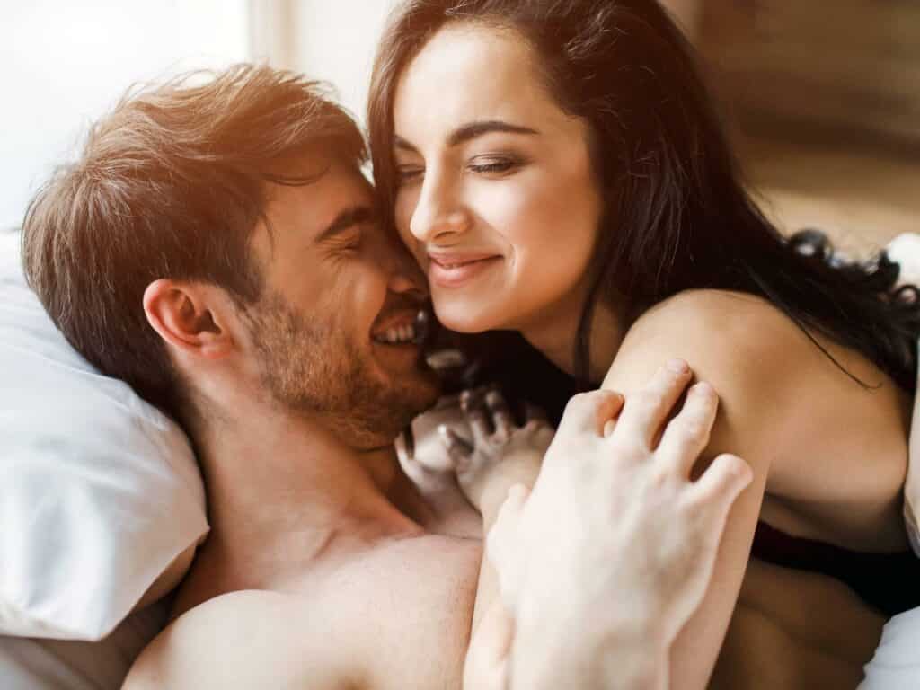 Intimate moment between man and woman in bed restoring sexual intimacy after a sexless marriage