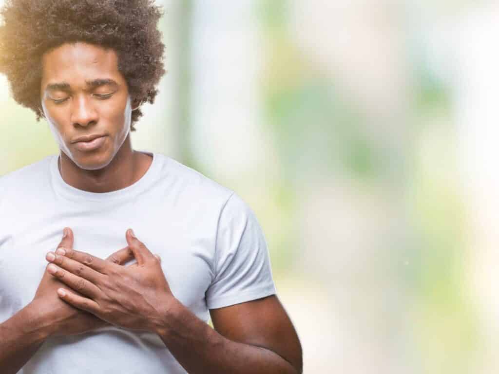 Person with hand over heart wondering how to be a force of good in the world.