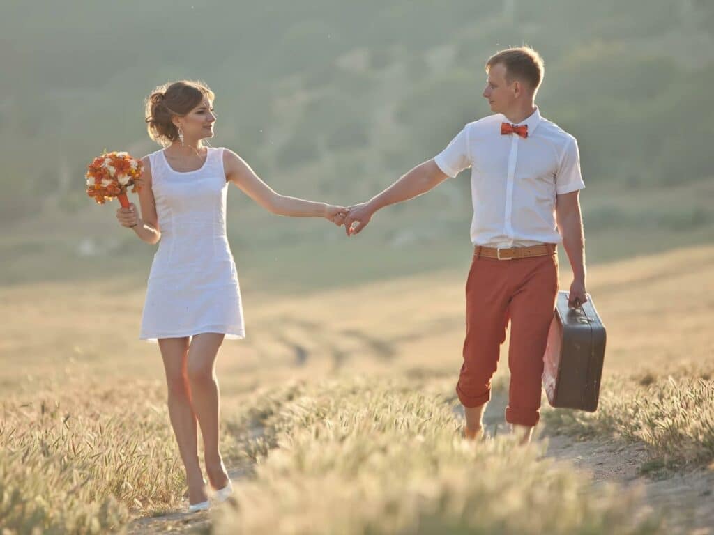 couple in a field holding hands learning how to build a marriage that lasts a lifetime
