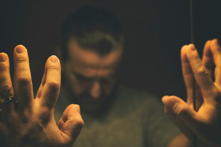 Man looking down at mirror wondering What to Do When Your Partner Has a Problem.