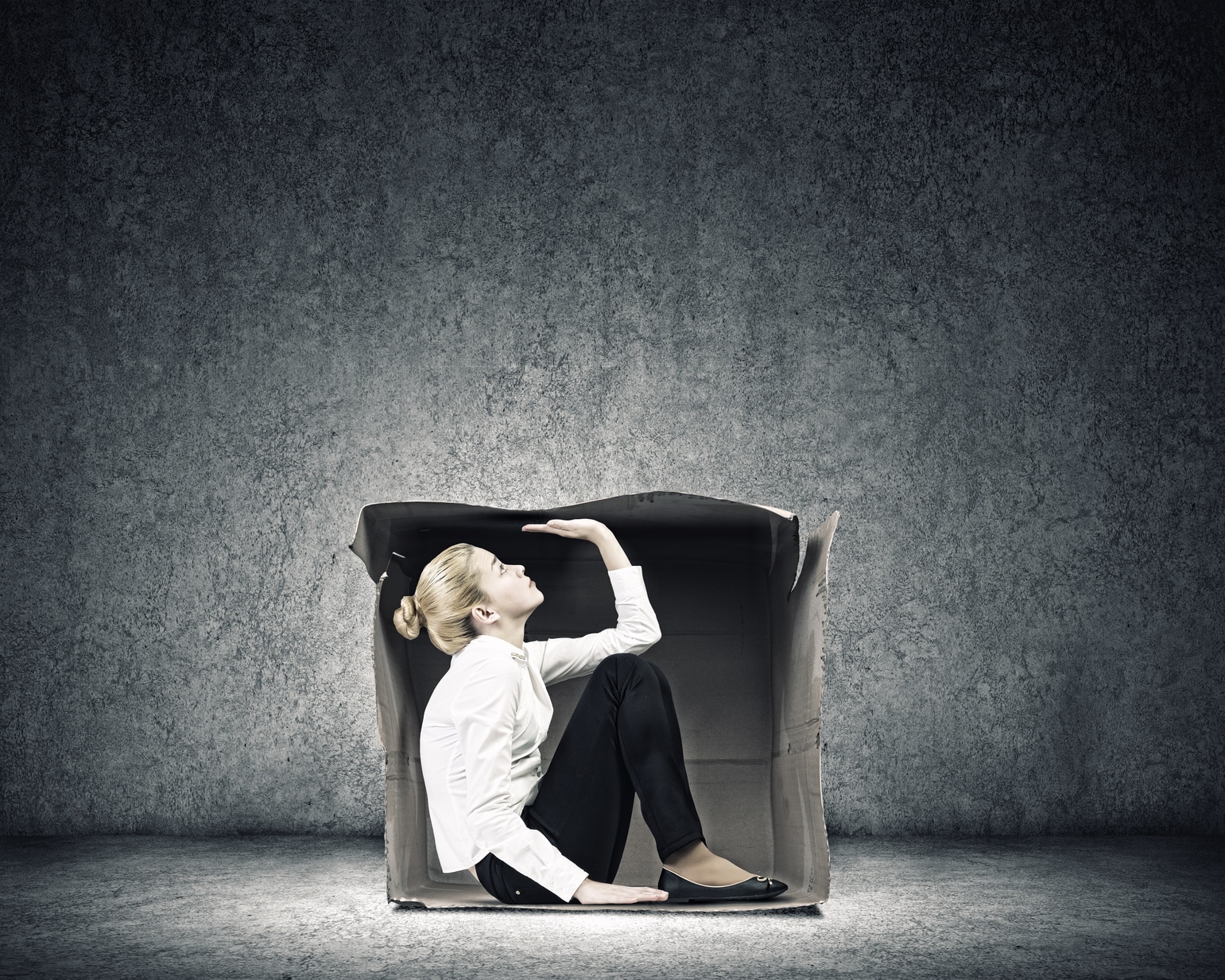 Woman in a cardboard box wondering how to stop worrying