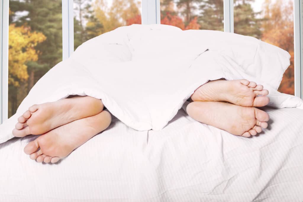 couple under covers with feet sticking out going to Bed Angry