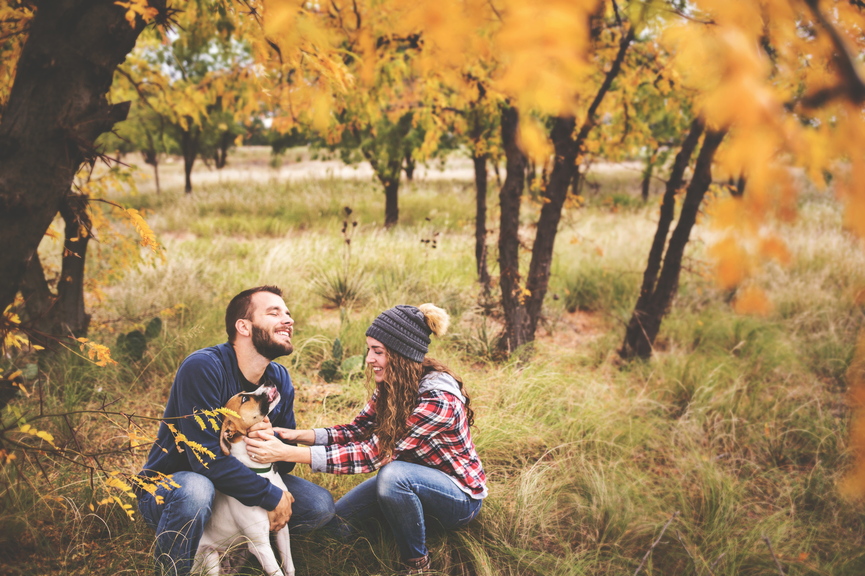 Couple outside with a dog practicing communication tips
