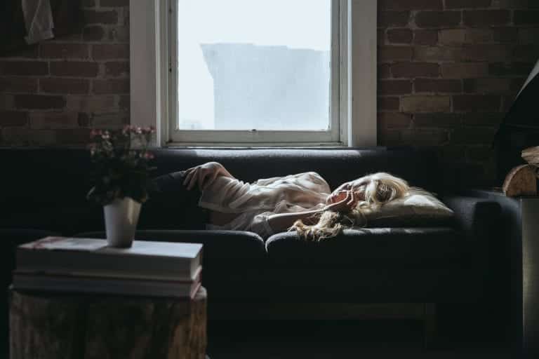 Person on a couch dealing with heartbreak