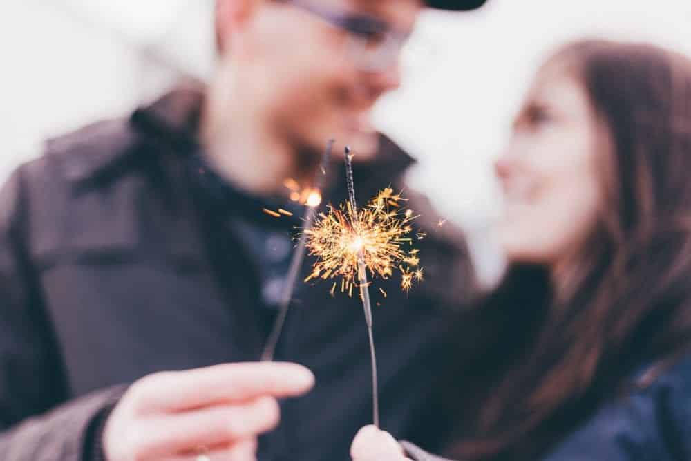 Couple lighting sparklers representing Lost Spark in Relationship