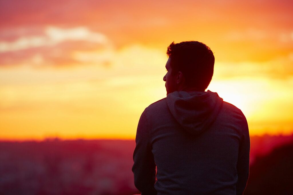 Man looking out at sunset representing How to understand men.