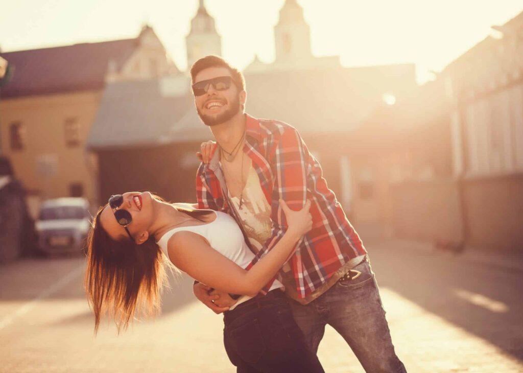 Couple dancing and having fun outside figuring out the new rules for finding love