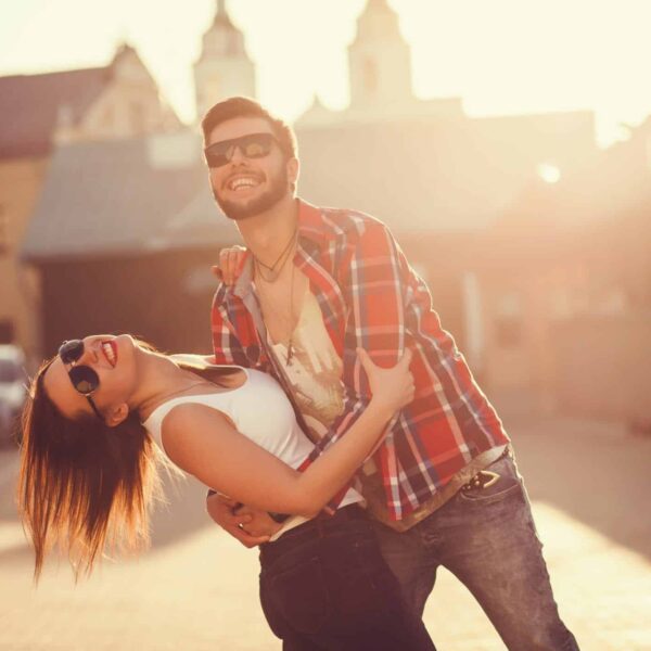 Couple dancing and having fun outside figuring out the new rules for finding love