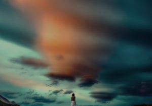 Woman looking at a gorgeous sky ready to leave a toxic relationship, with dignity.