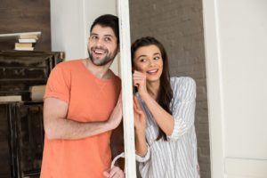 Man and woman separated by a wall but listening for each other's bids for affection