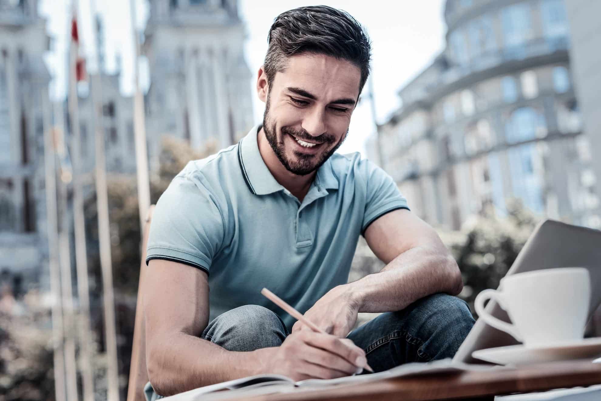 Man writing in a notebook finding a career he loves