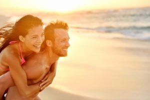 How Men Feel Loved: Man and woman on beach having fun with good relationship and emotional intimacy.