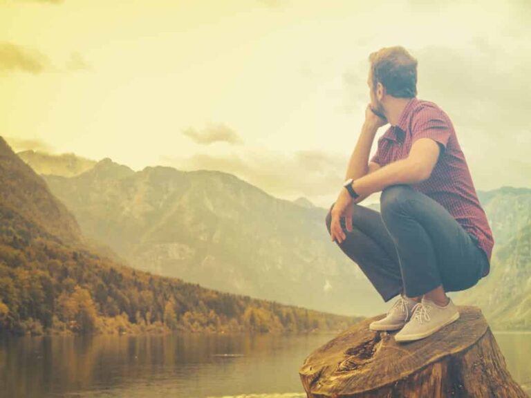 Man hiking, looking out at the view and designing his life