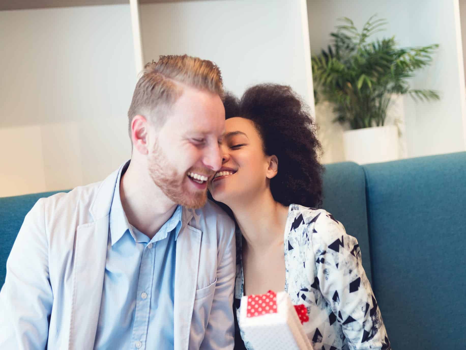 woman using the power of praise and whispering something in man's ear