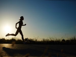 person running at sunset feeling self empowered