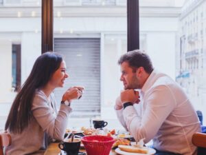 Man and woman dating after divorce talking on a date at a restaurant.