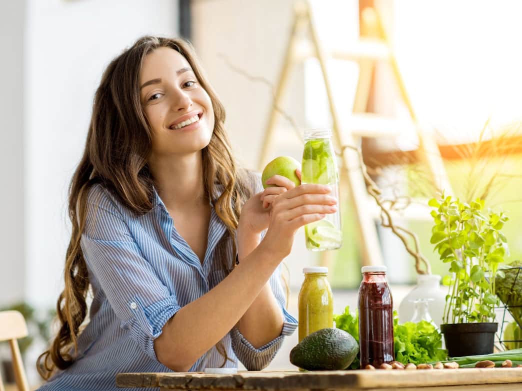 Woman with a bunch of healthy food around her representing Nutrition and Mood.