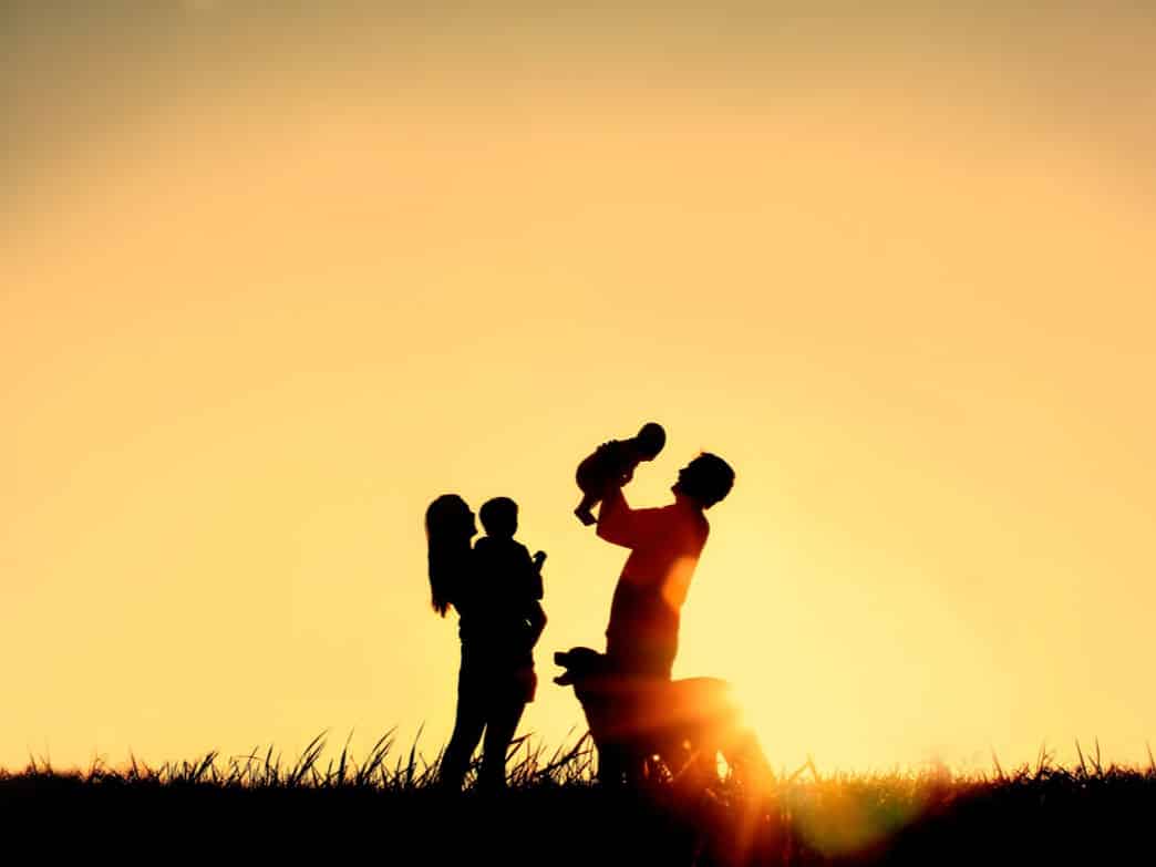 Family outside in the sunset representing Parenting Two Under Two.