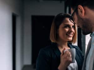 Married with a crush? Woman holding mug looking up at man.