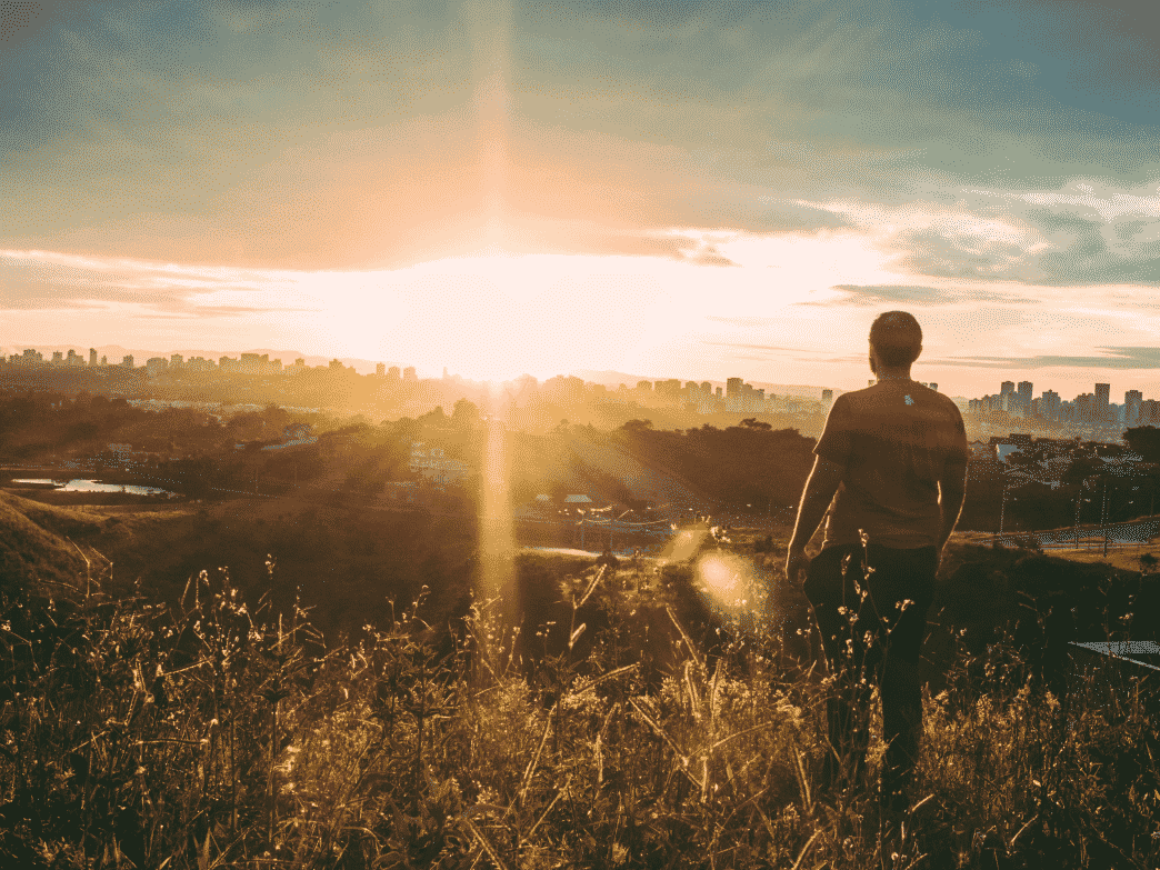 Man on a hill overlooking city. Resilience: How to adapt to change