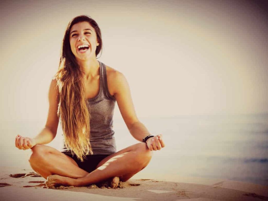 Women meditating on beach representing Stress Management Tips to Regain Your Inner Peace