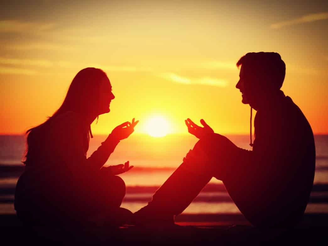 Couple talking at sunset. How to improve communication.