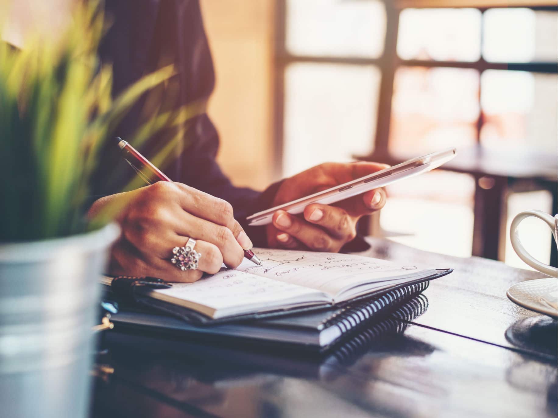 Woman taking notes representing How to Keep Calm With a Self-Care Plan