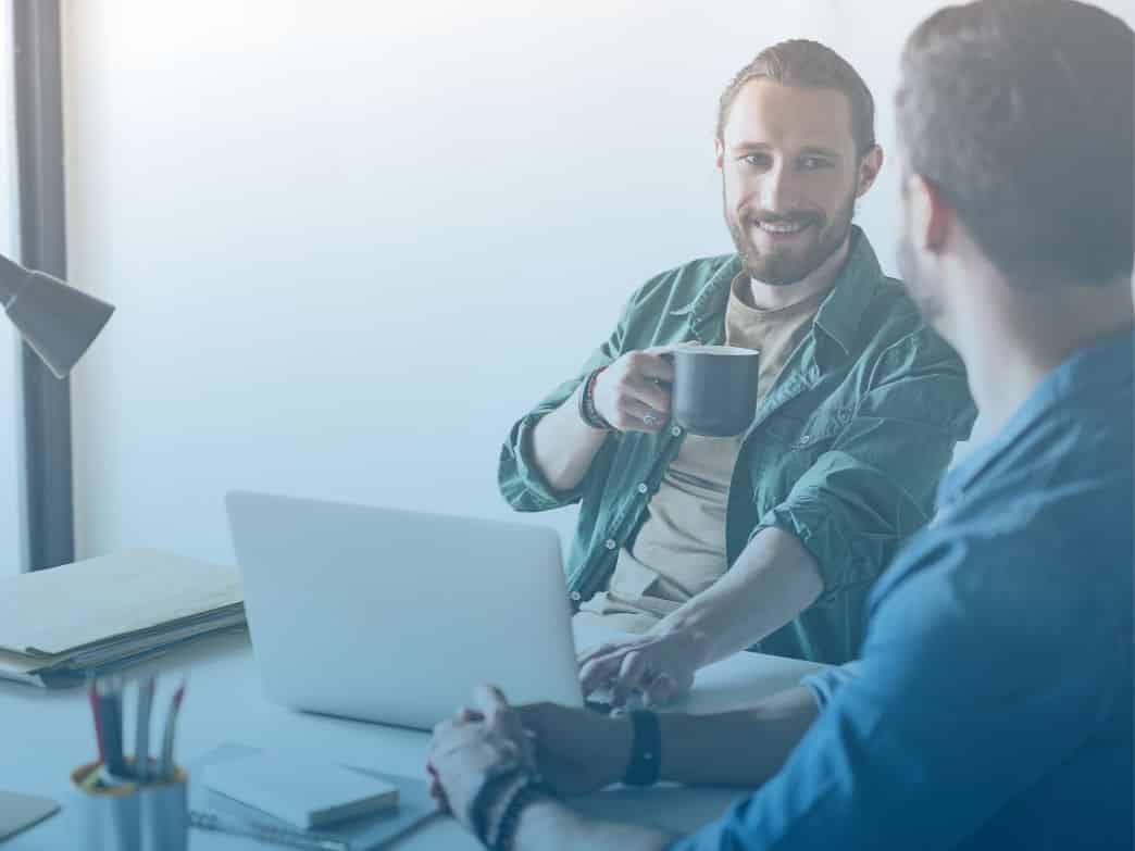 Two men chatting. The impact of emotional intelligence.