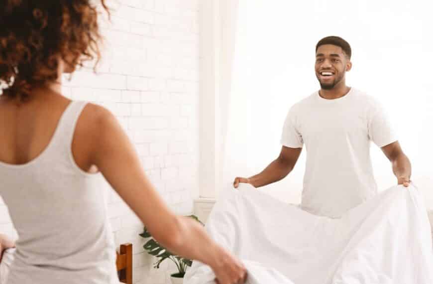 Couple making the bed. Egalitarian Relationship.