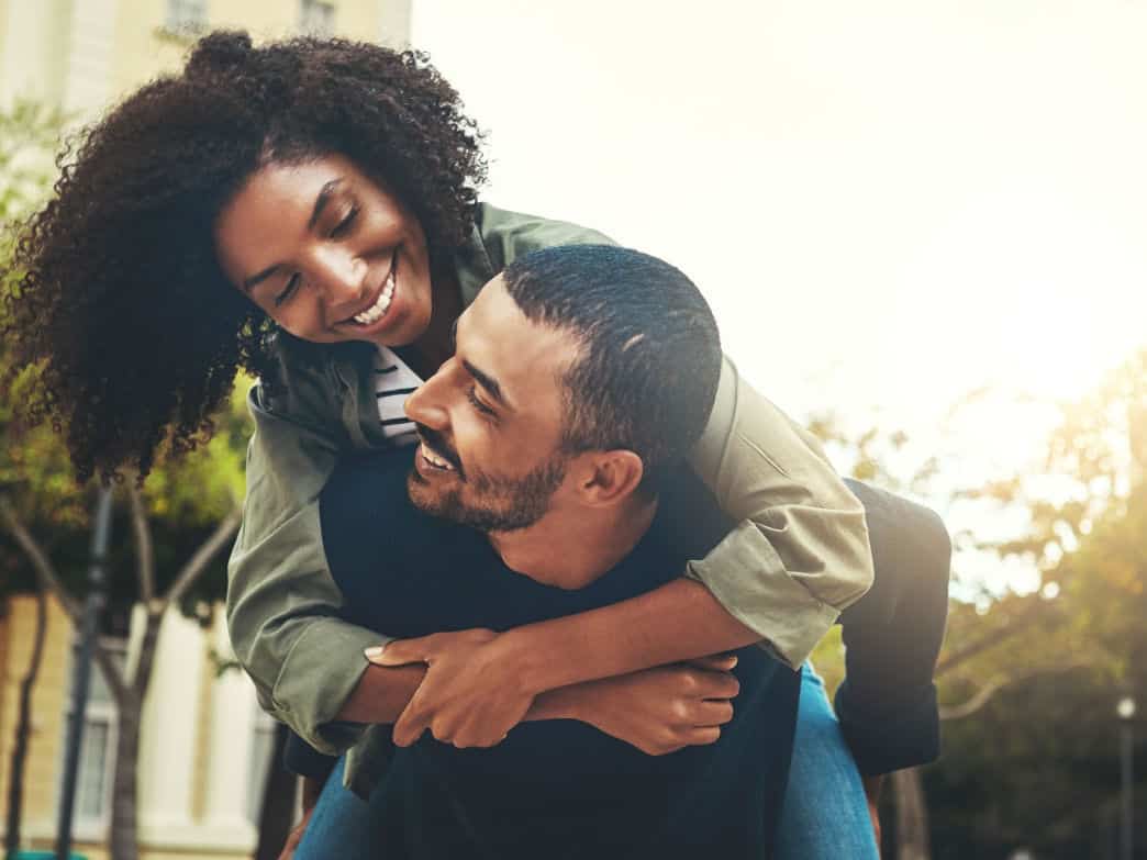 man carrying woman on his back. Nourishing friendship with partner.