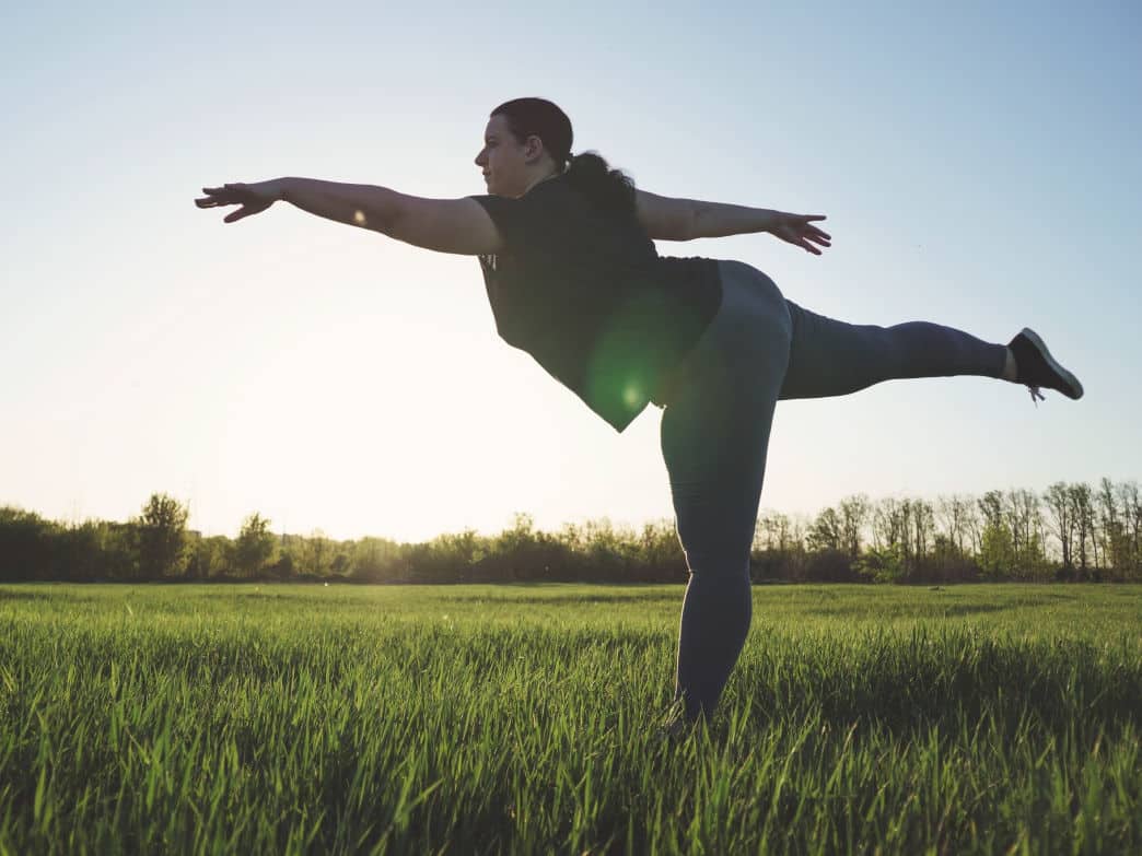 Woman doing yoga on the grass. How to love yourself, unconditionally.