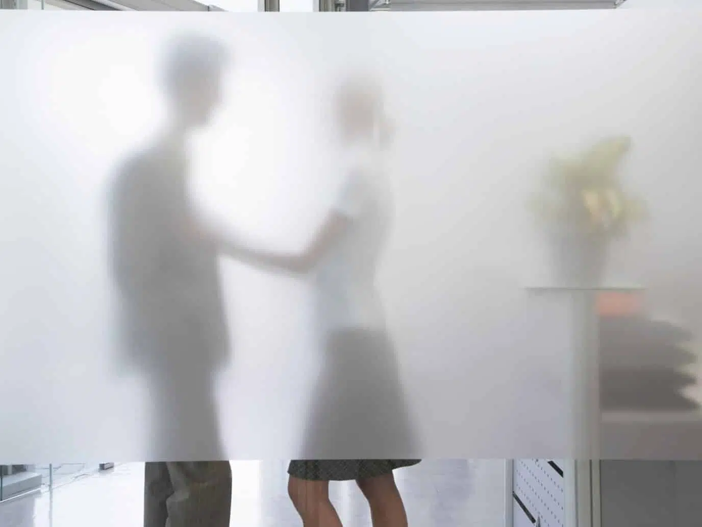 Man and woman in an office representing Office romance pros and cons.