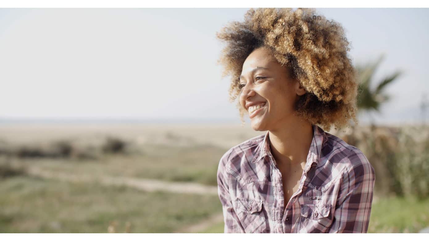 Woman smiling outside representing Developing Self-Esteem: One Thought at a Time