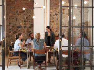 People collaborating at a table. How to build positive working relationships.