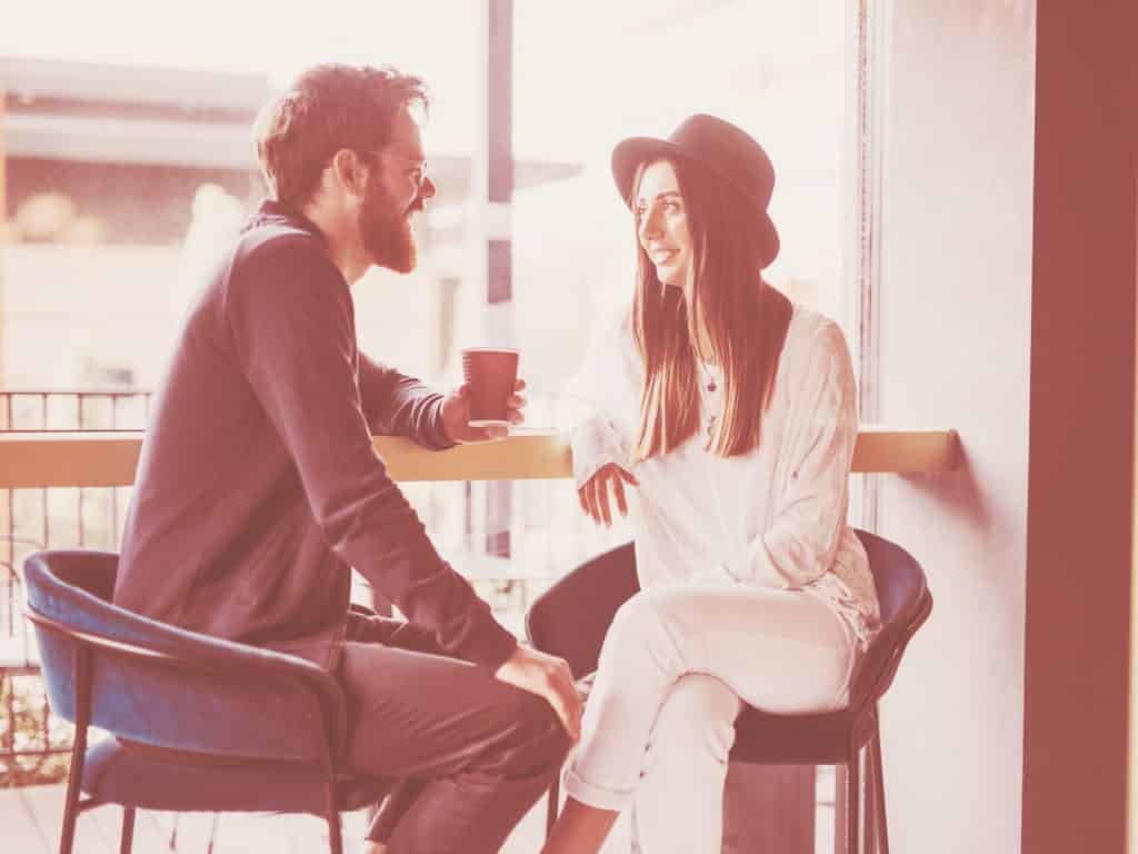 Man and woman on a date at a coffee shop representing Sad About Being Single?