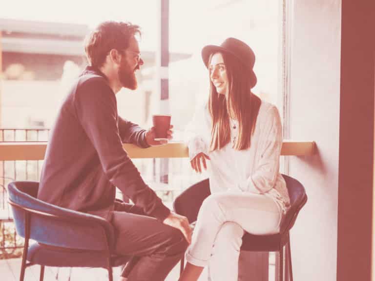 Man and woman on a date at a coffee shop representing Sad About Being Single?